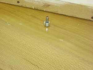 A pivot point created with a steel pin, brass bushings and steel stop collar.