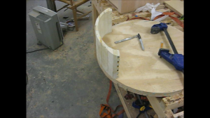 A plywood circle used to force the polygon into a circle during glue up is a valuable tool to lay out the drawer box curvature and fine-tune the final surface